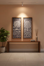 Two framed artworks on a wall above a wooden console table with decorative items.