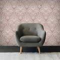 Gray armchair against a patterned wallpaper wall