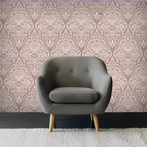 Gray armchair against a patterned wallpaper wall