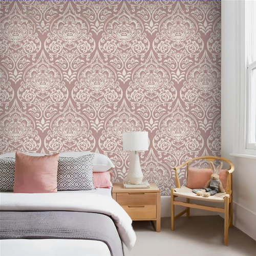Bedroom with pink and white patterned wallpaper, bed with pillows, nightstand, and chair.