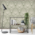 Decorative wallpaper with a green and white pattern in a room with a shelf and chair.