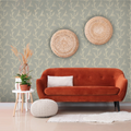 Orange sofa in a room with decorative wall art and plants.