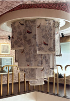 Set of patterned towels hanging on a rack in a store setting.