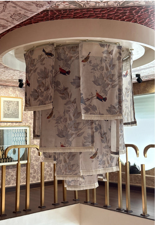 Set of patterned towels hanging on a rack in a store setting.