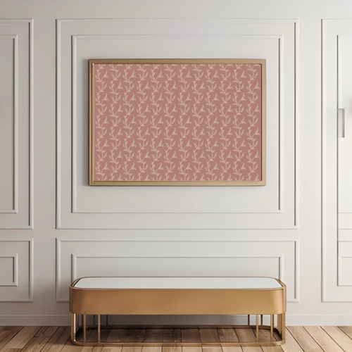 Patterned pink wall art on a white paneled wall with a gold bench below.