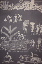 Textile with Warli art featuring abstract human figures and nature elements on a dark background
