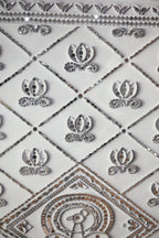 Decorative tiles with geometric patterns and embellishments on a white background
