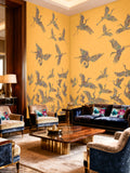 Luxurious living room with yellow walls featuring bird patterns, dark blue sofas, and decorative pillows.