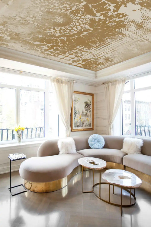 Modern living room with a curved sectional sofa, coffee tables, and decorative elements.