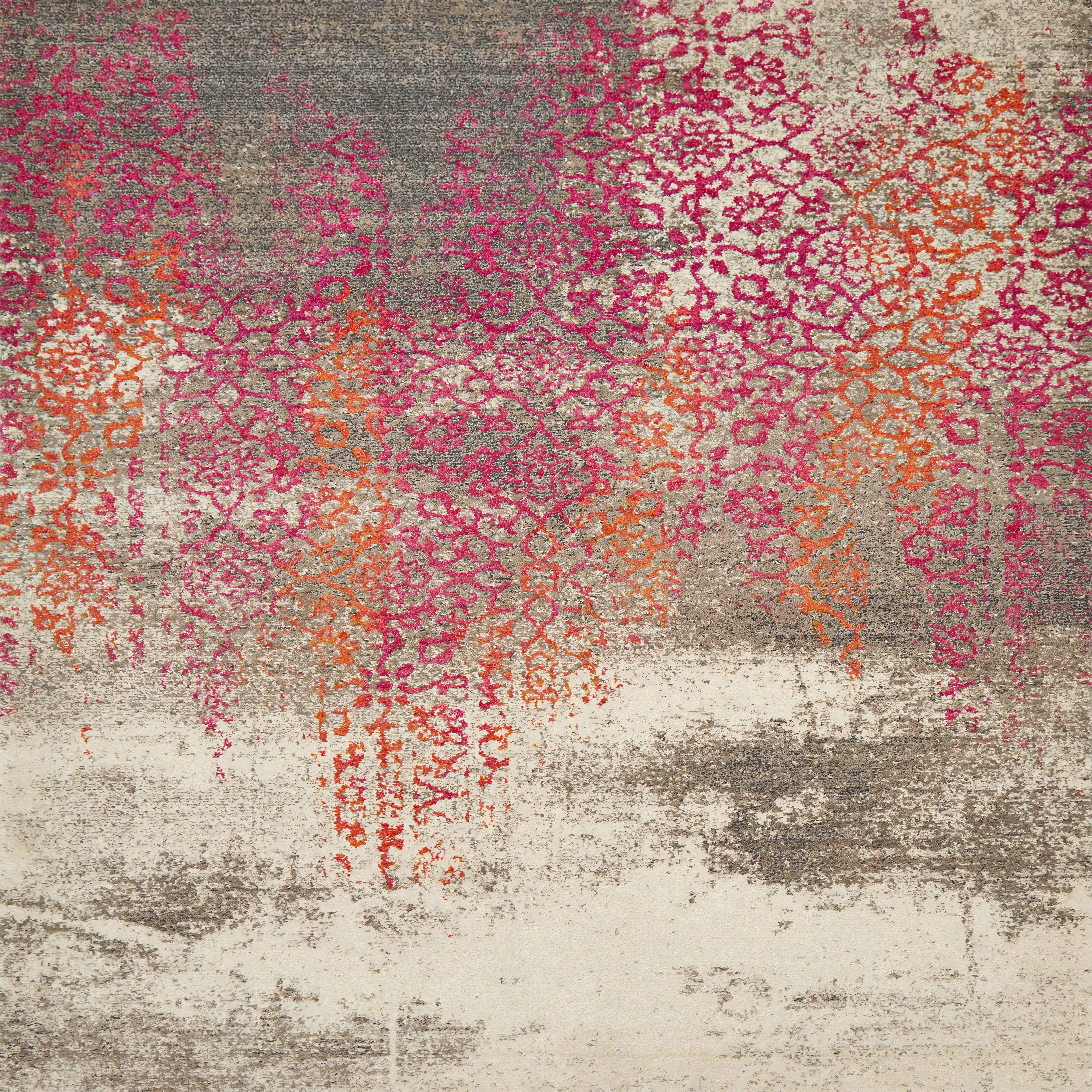 Patterned rug with pink, orange, and gray colors