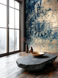 Modern interior with a decorative wall, stone table, and gold bowl.