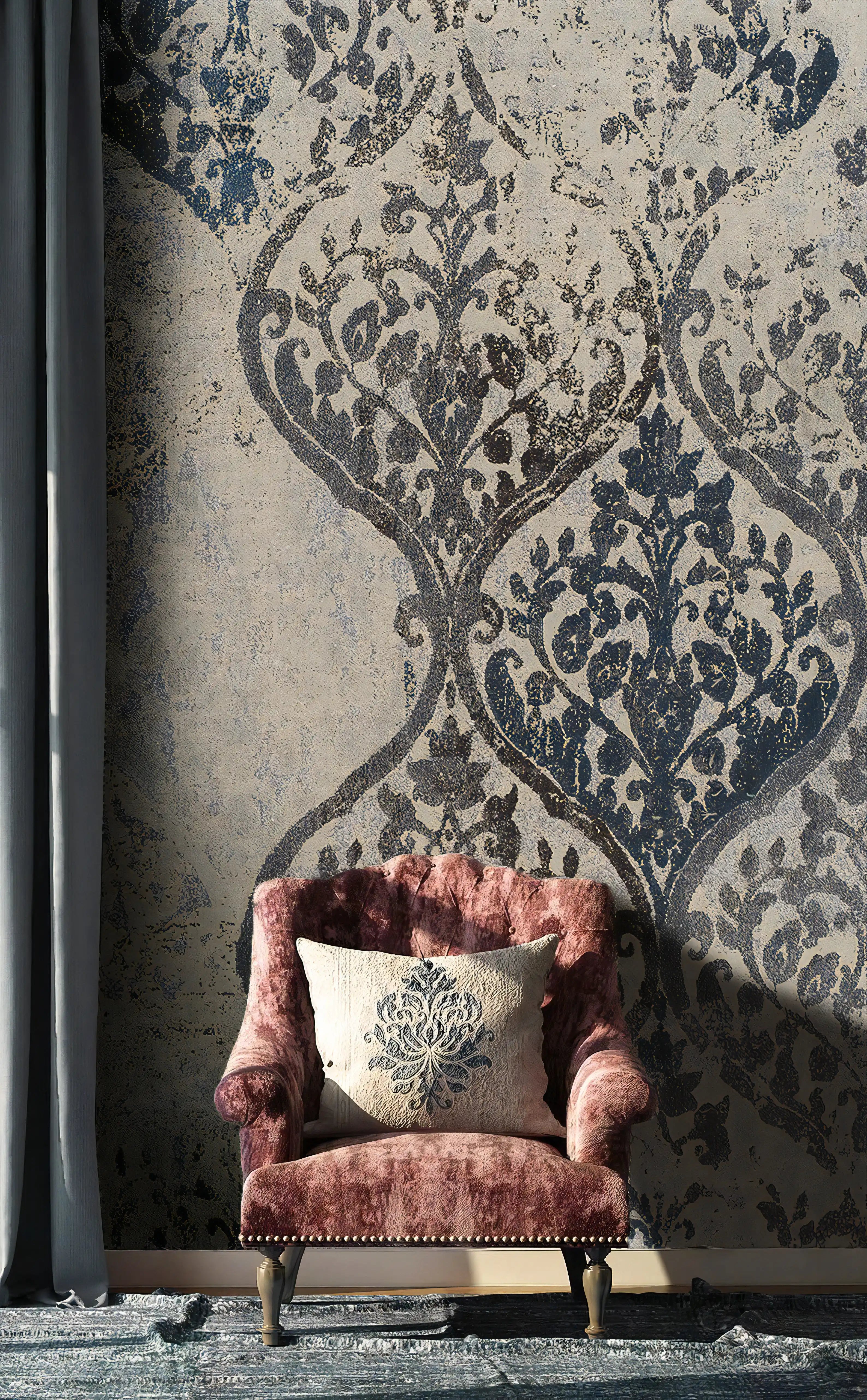 Pink armchair with a decorative pillow against a patterned wall.