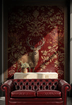 Red leather sofa in front of a decorative wall with a deer and floral pattern.