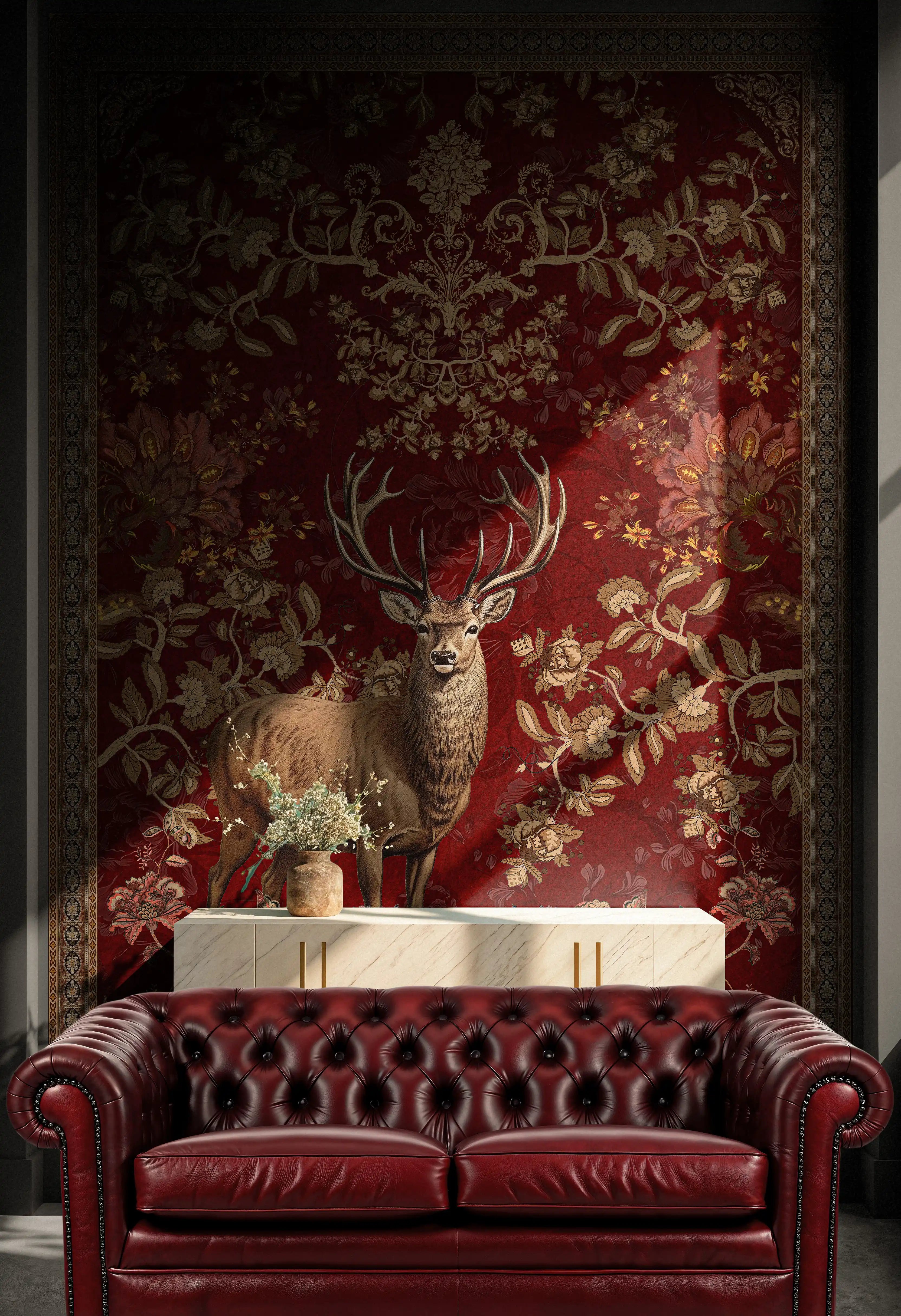 Red leather sofa in front of a decorative wall with a deer and floral pattern.