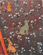 Decorative fabric with embroidered animals and flowers on a brown background