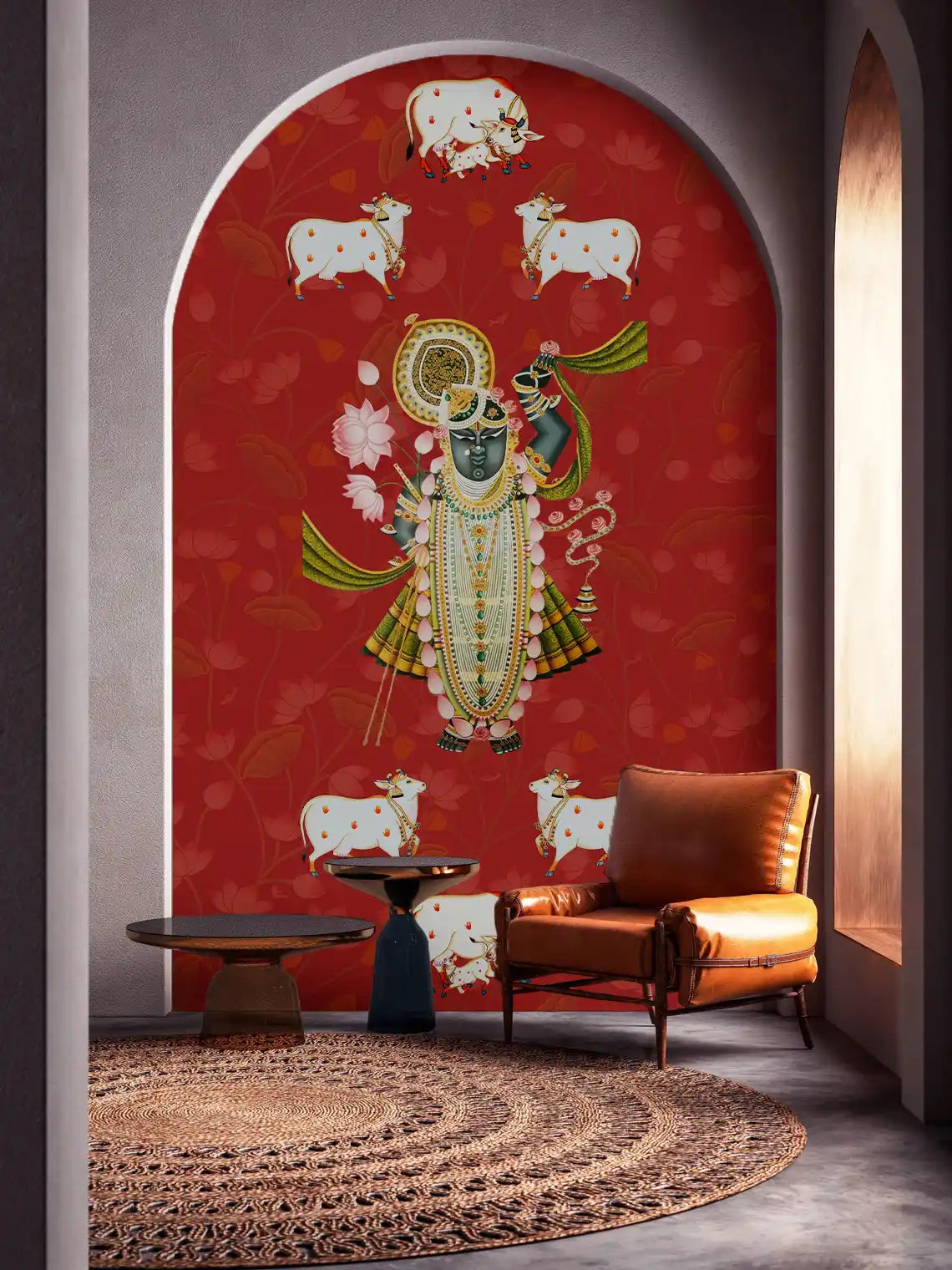 Decorative wall mural with a central figure and cows on a red background, featuring a brown leather chair and small table.