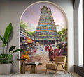 Decorative wall mural of a colorful temple with people in a street scene, featuring a chair and plant in a room.