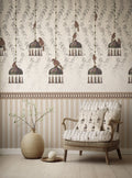 Patterned wallpaper with hanging bird design and a matching armchair in a room.