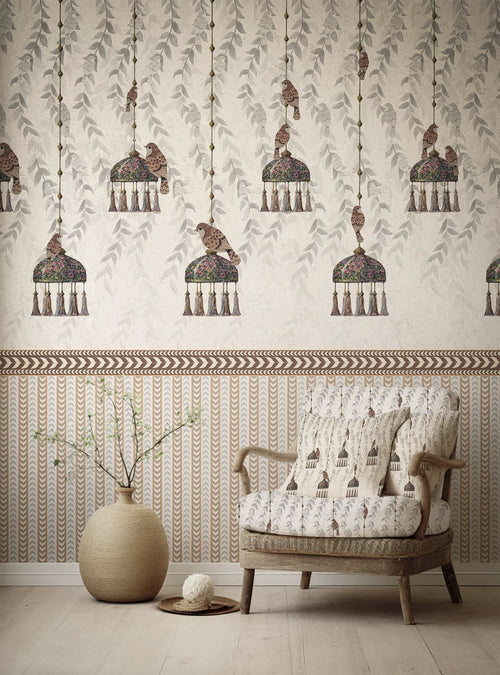 Patterned wallpaper with hanging bird design and a matching armchair in a room.