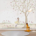 Children's room with tree wall decal, swing, and rocking horse.