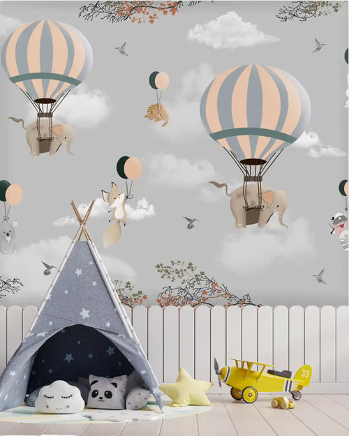 Children's room with a teepee, toys, and a wall with hot air balloons and elephants.