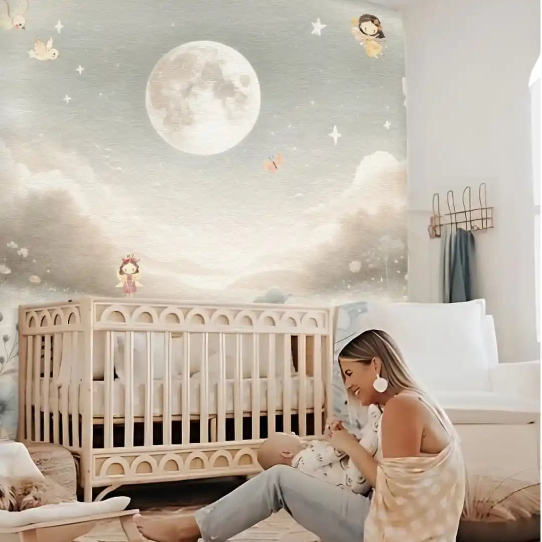 Woman sitting next to a crib in a nursery with a moon and star mural on the wall.
