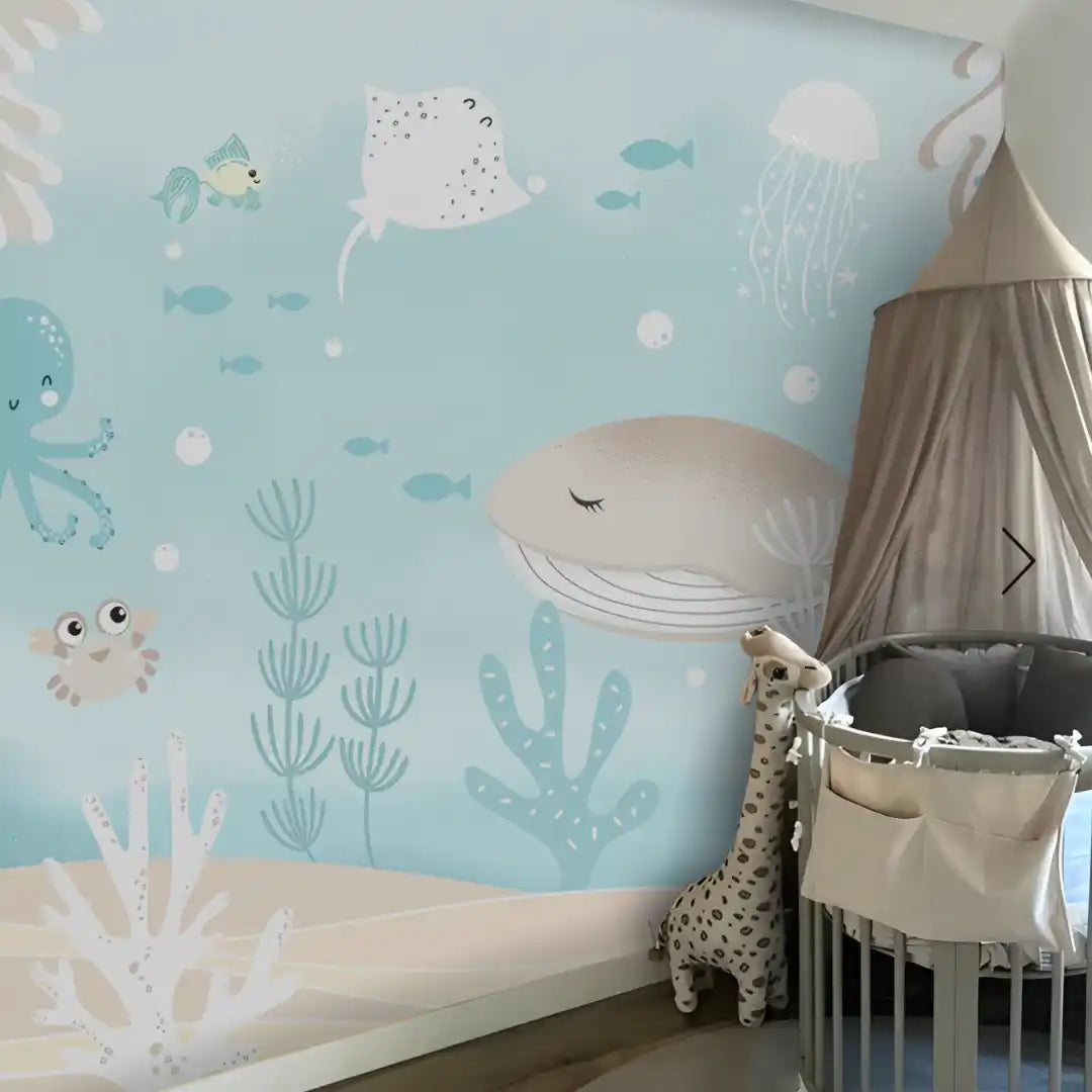 Children's room with ocean-themed wallpaper, crib, and stuffed animal.