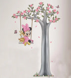 Wall decal of Minnie Mouse on a swing with a tree and butterflies.