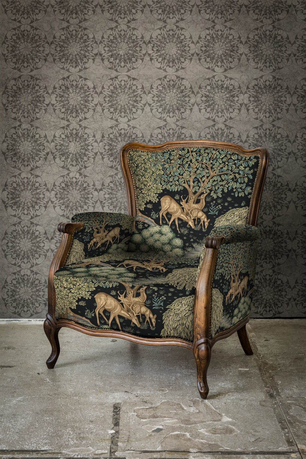 Decorative armchair with tapestry design against a textured wall.