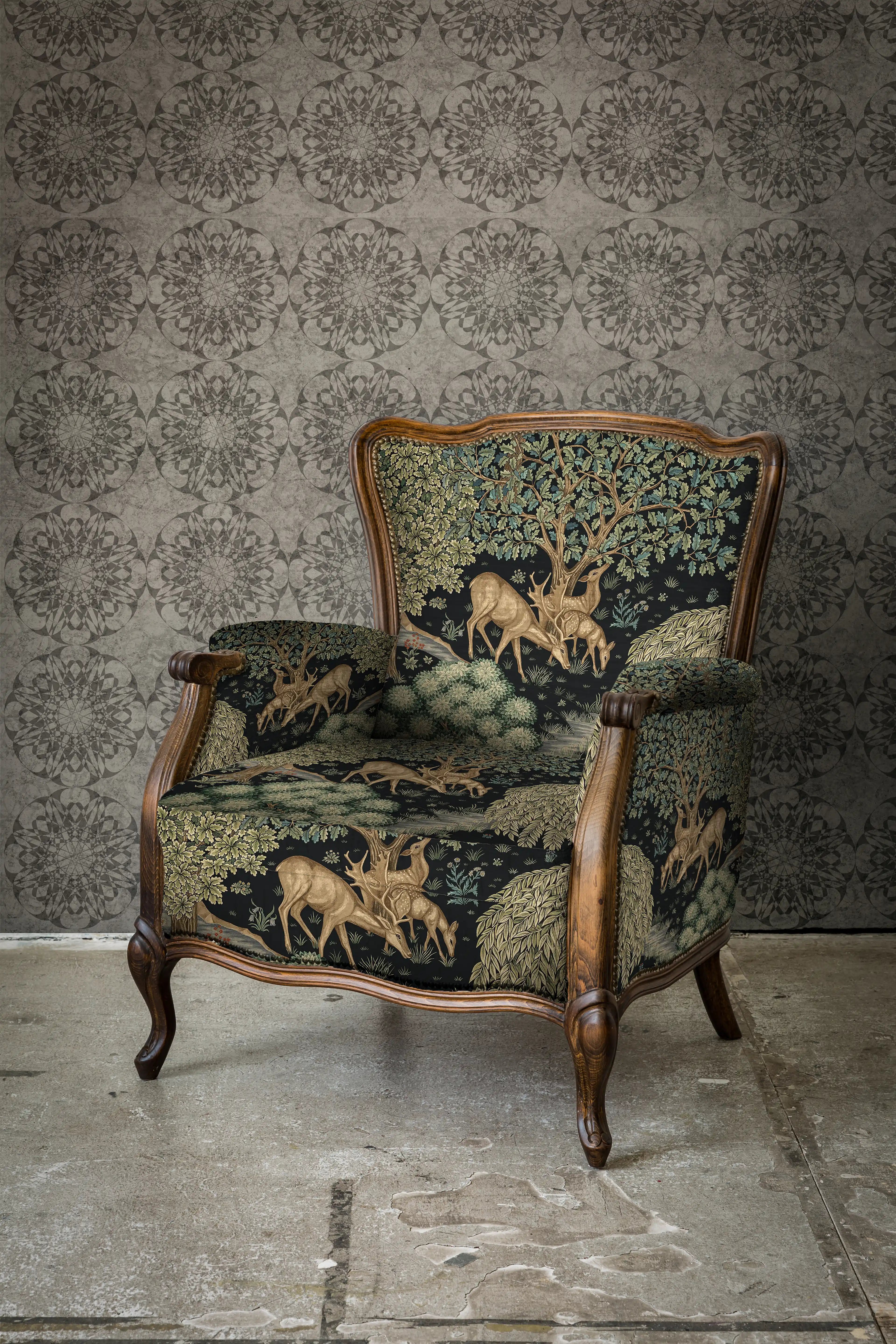 Decorative armchair with tapestry design against a textured wall.