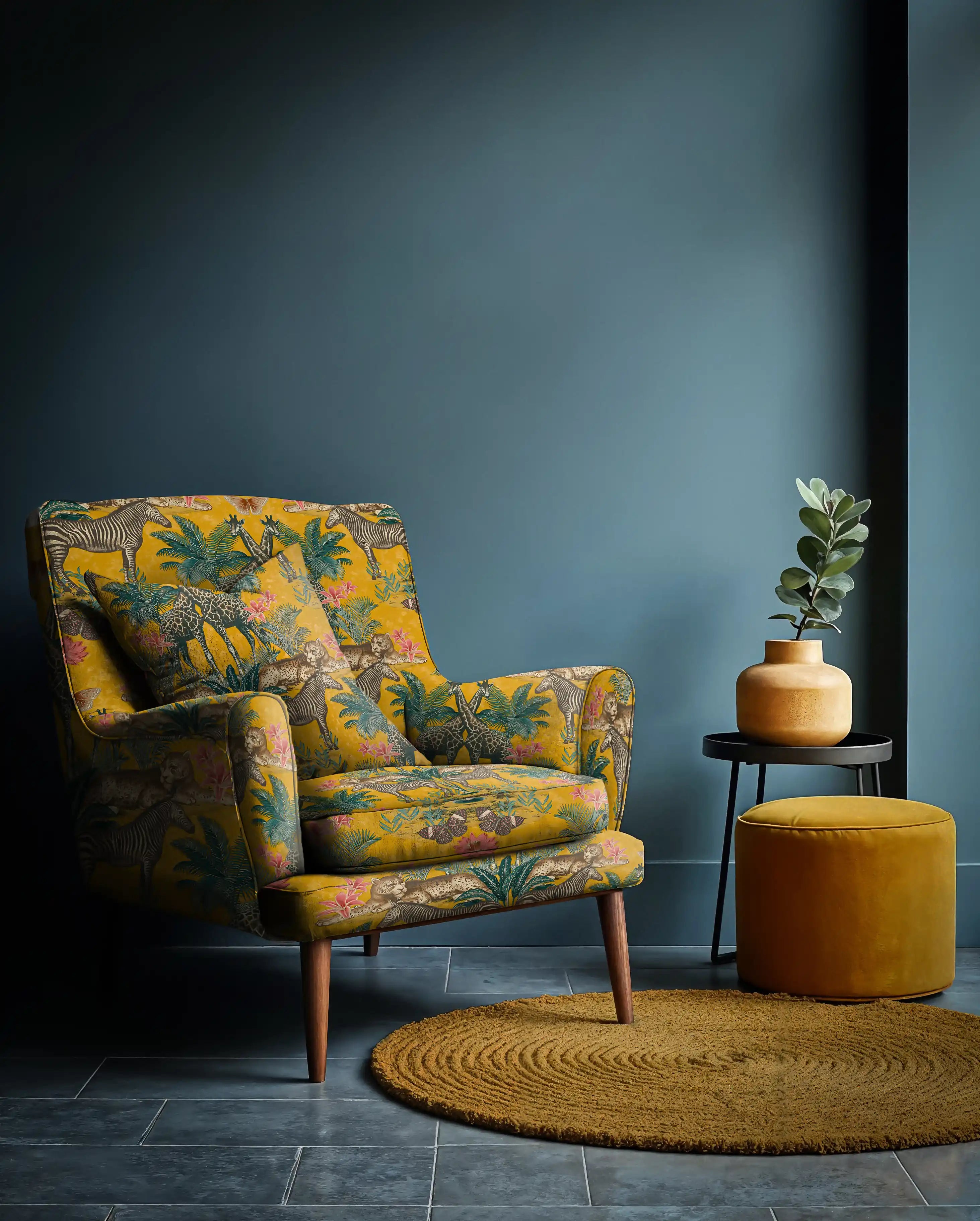 Patterned armchair in a room with a blue wall and round rug